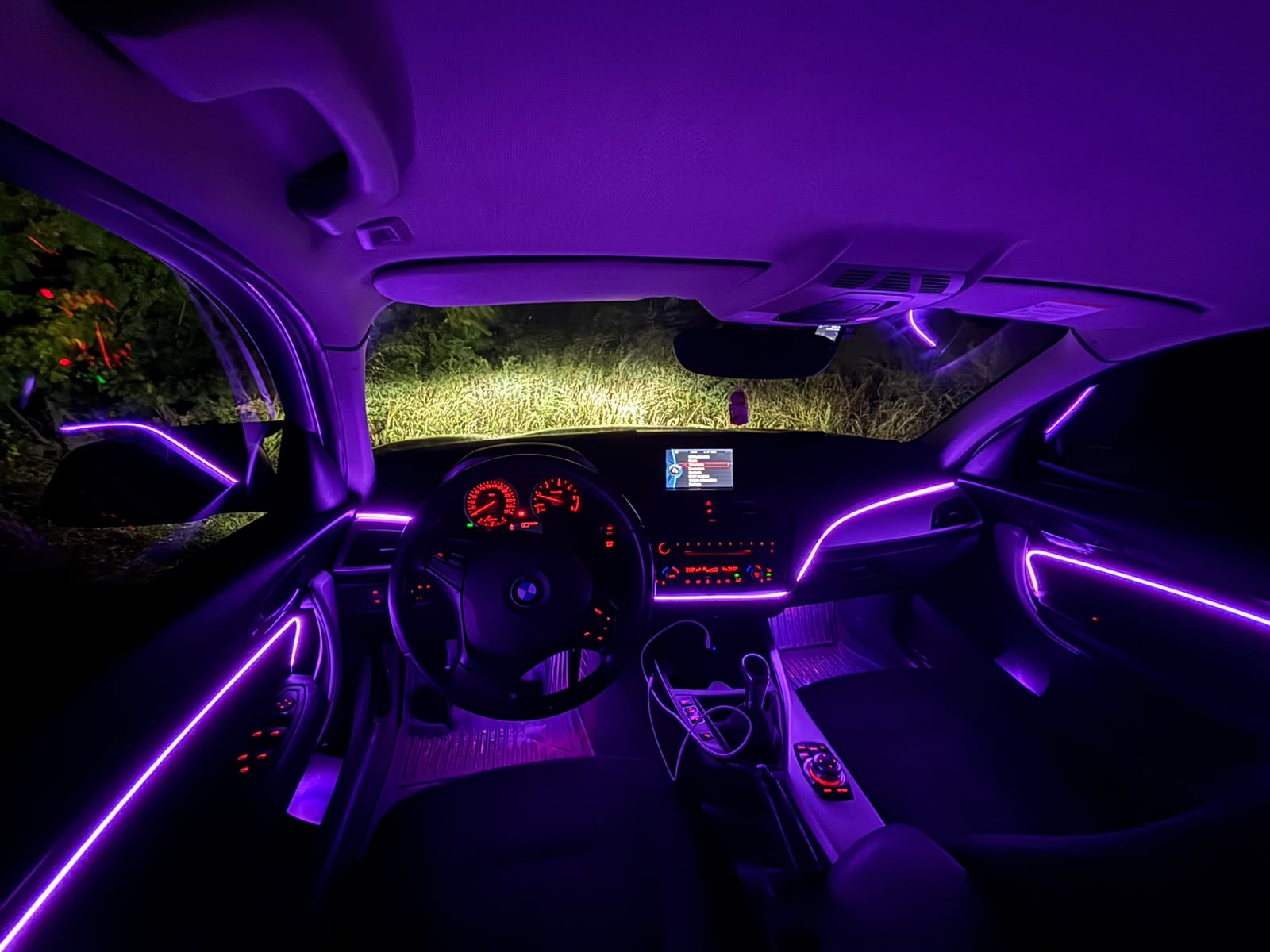 Car interior with purple ambient lighting installed by AutoWired